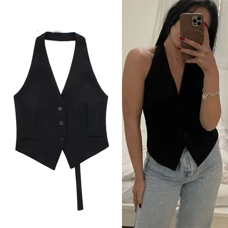 Halter Neck Waistcoat Top 1 Woman modeling a sleek black backless halter neck waistcoat top paired with light-wash blue jeans, showing the flat lay product shot on the left and a mirror selfie on the right.